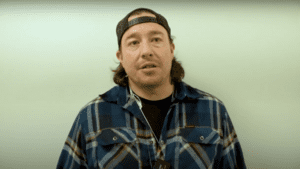 Jarred Sparrow in a plaid shirt and a cap.